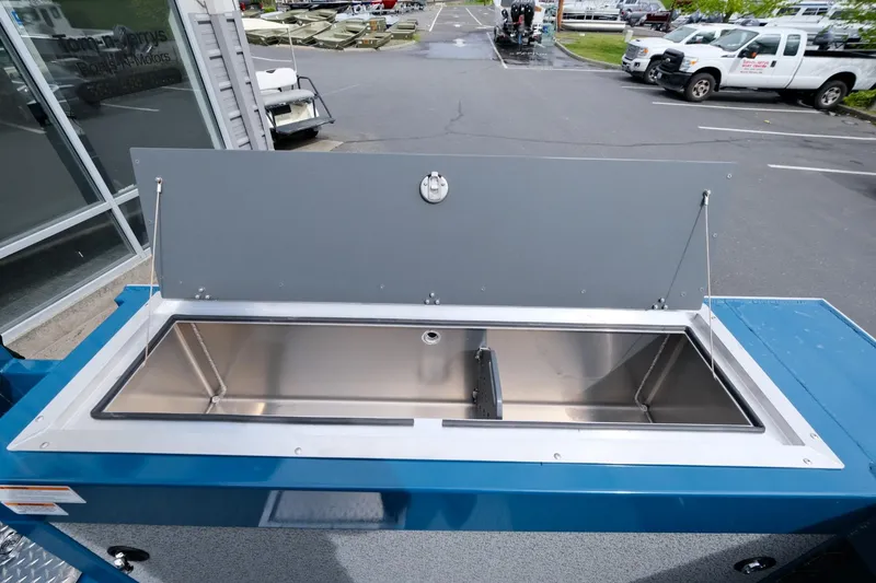 Slide: The Image of 2024 Hewescraft 220 Ocean Pro boat with open storage compartment. - 15