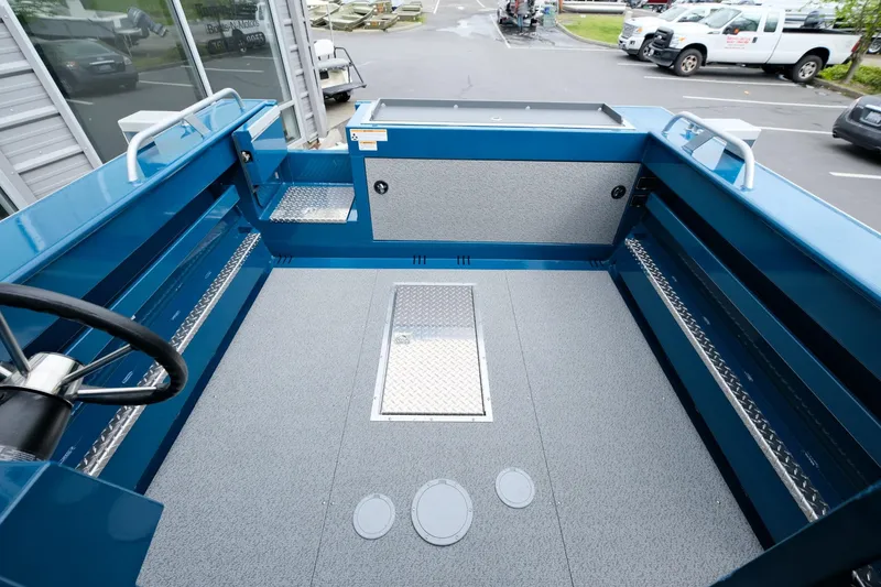 Slide: The Image of 2024 Hewescraft 220 Ocean Pro boat interior with spacious deck and storage compartments. - 7