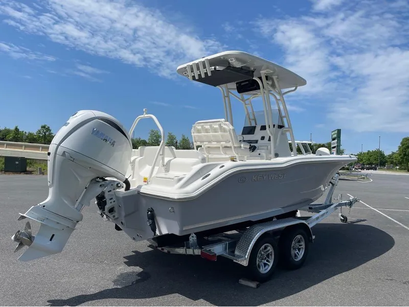 Slide: The Image of 2024 Key West 219 FS boat with Yamaha outboard motor on trailer. - 17