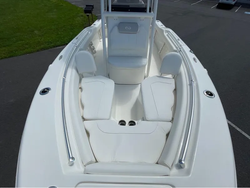 Slide: The Image of 2024 Key West 219 FS boat interior with cushioned seating and stainless steel railings. - 18