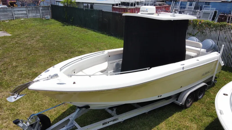 Slide: The Image of 2006 Robalo R260 Center Console boat on a trailer in a grassy area. - 16