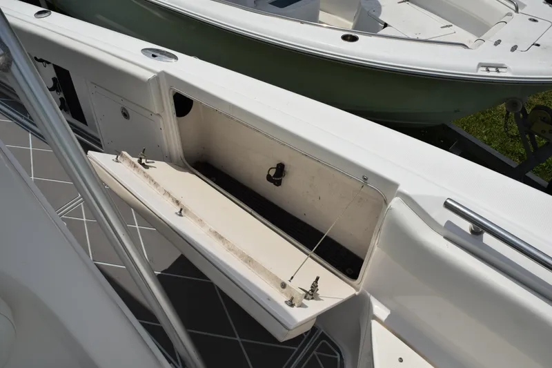 Slide: The Image of 2006 Robalo R260 Center Console storage compartment open. - 34
