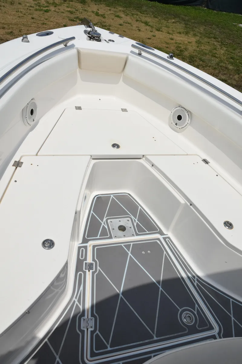 Slide: The Image of 2006 Robalo R260 Center Console boat deck with storage compartments. - 35
