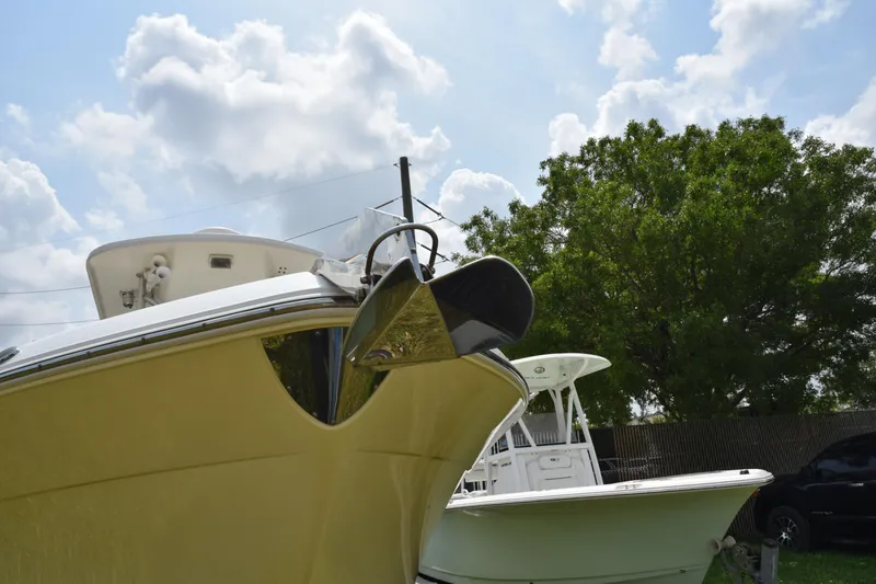 Slide: The Image of 2006 Robalo R260 Center Console boat with anchor, parked outdoors. - 4