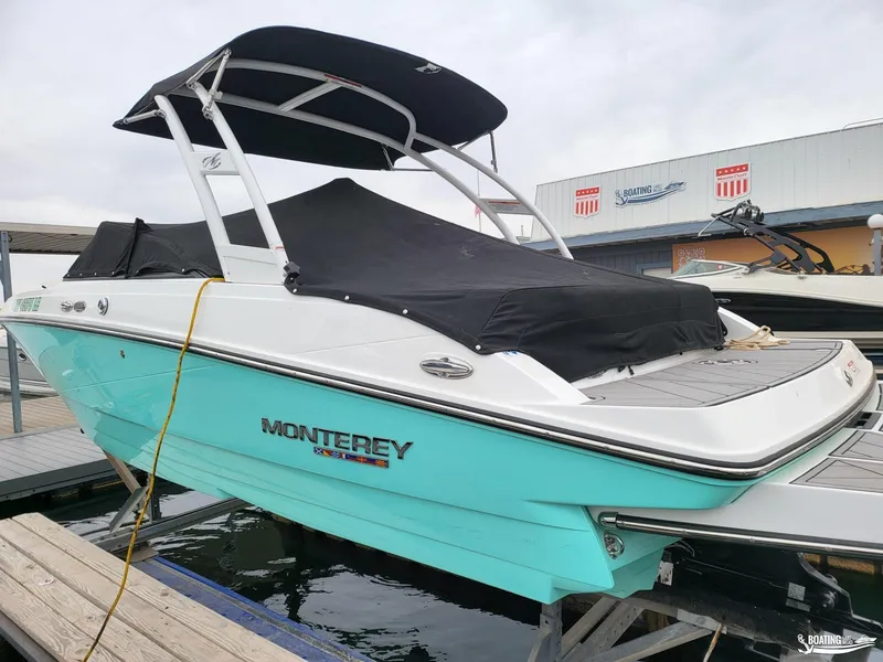 Slide: The Image of 2023 Monterey M22 boat with black canopy docked at marina. - 10