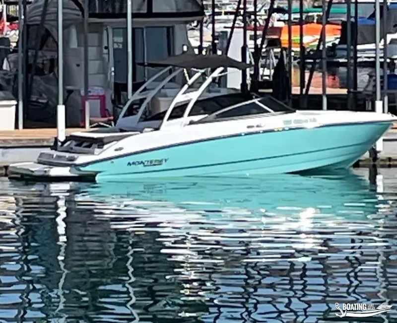 Slide: The Image of 2023 Monterey M22 boat docked at marina with turquoise hull. - 14