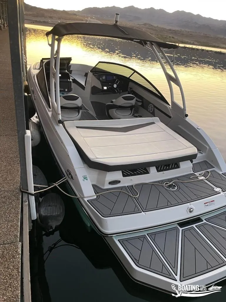 Slide: The Image of 2023 Monterey M22 boat docked at sunset with sleek design and modern features. - 18