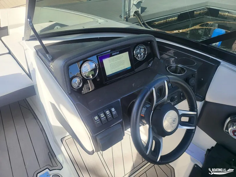 Slide: The Image of 2023 Monterey M22 boat dashboard with steering wheel and digital display. - 22
