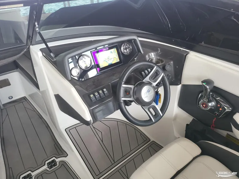 Slide: The Image of 2023 Monterey M22 boat cockpit with steering wheel, control panel, and navigation display. - 25