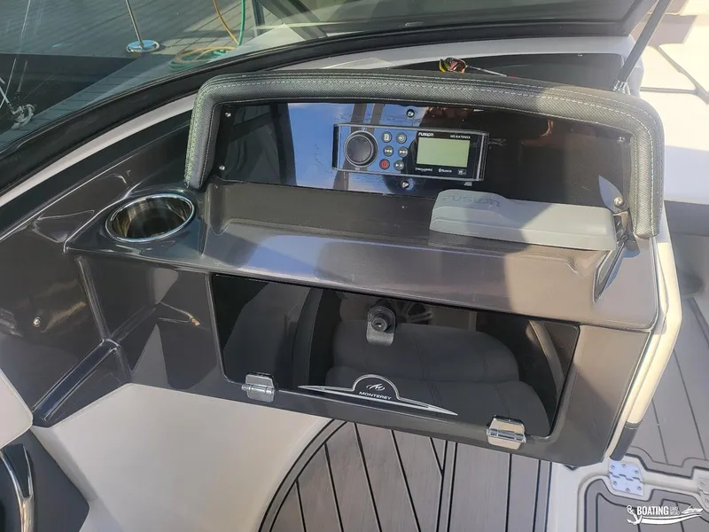Slide: The Image of 2023 Monterey M22 boat dashboard with stereo system and cup holder. - 26