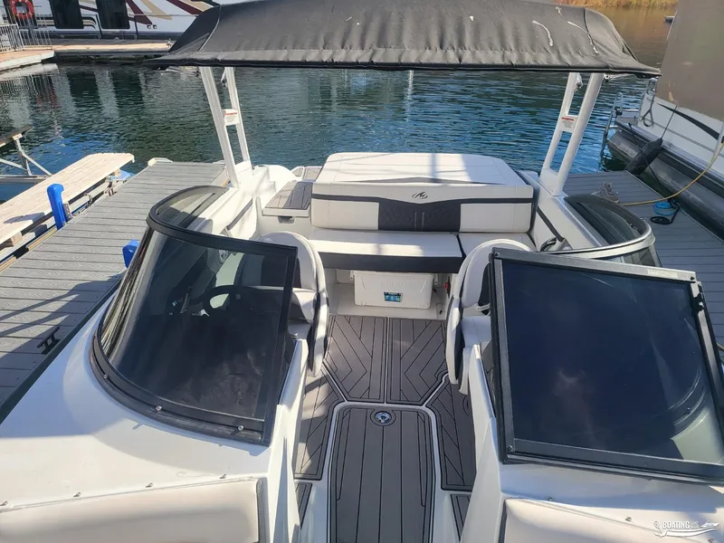 Slide: The Image of 2023 Monterey M22 boat with sleek interior design docked at marina. - 27