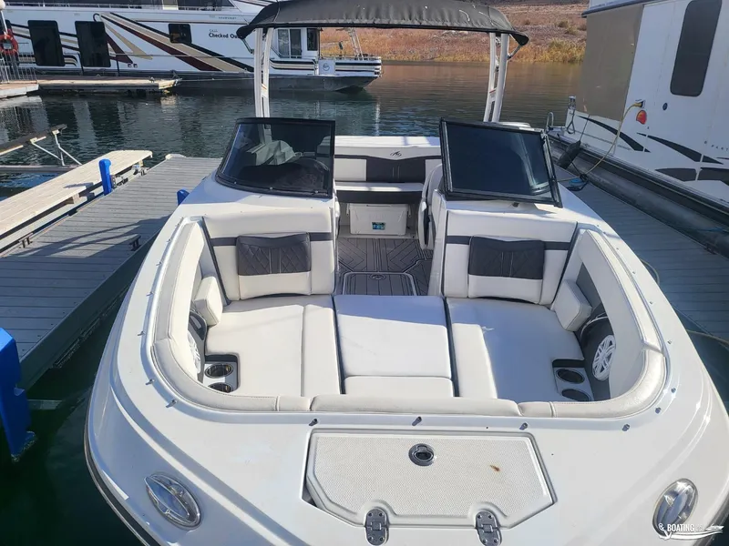 Slide: The Image of 2023 Monterey M22 boat with spacious seating, docked at marina. - 29