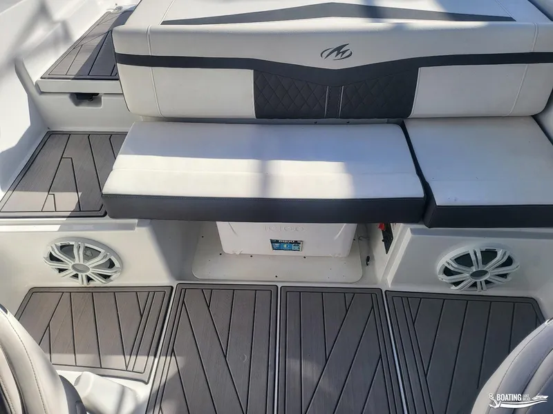 Slide: The Image of 2023 Monterey M22 boat interior with cushioned seating and stylish flooring. - 30