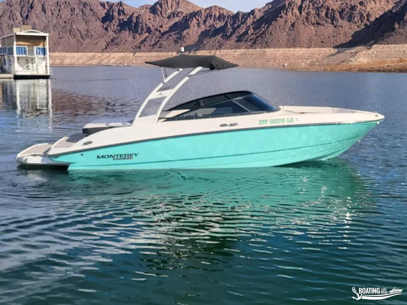 Slide: The Image of 2023 Monterey M22 boat on a serene lake with mountainous backdrop. - 4
