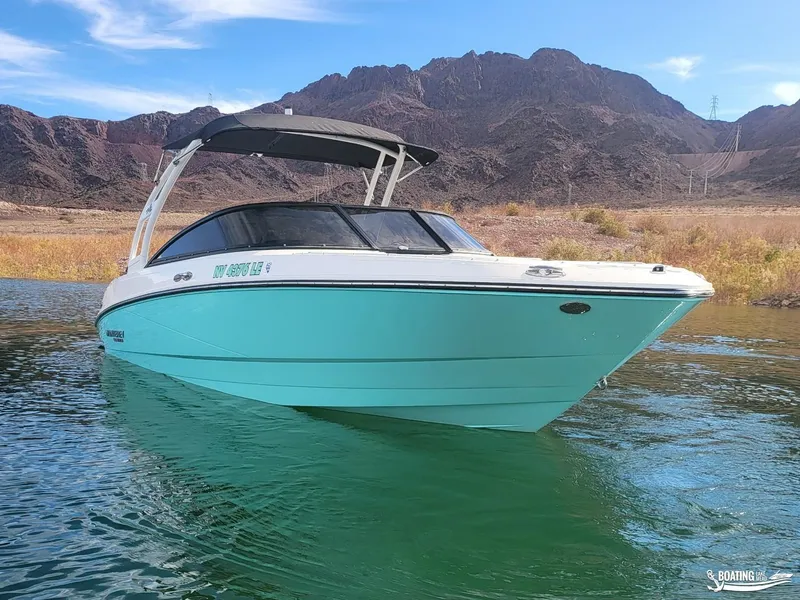 Slide: The Image of 2023 Monterey M22 boat on a lake with mountainous backdrop. - 6