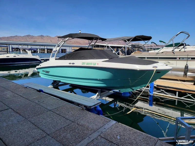 Slide: The Image of 2023 Monterey M22 boat docked at a marina with other boats. - 7