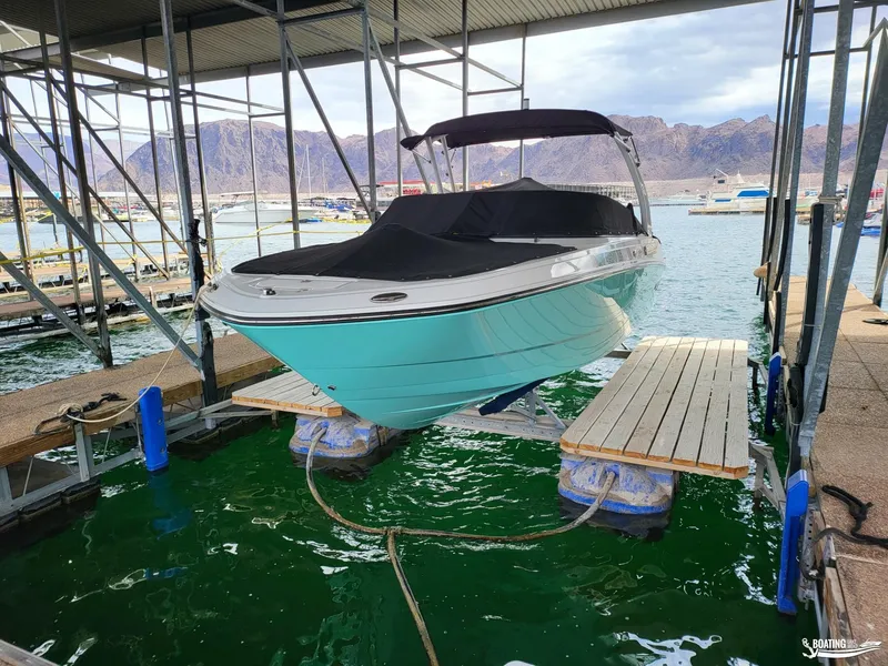 Slide: The Image of 2023 Monterey M22 boat docked in marina with scenic mountain backdrop. - 8