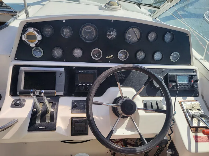 Slide: The Image of 1993 Sea Ray Laguna 29 Walkaround dashboard with steering wheel and control panel. - 10