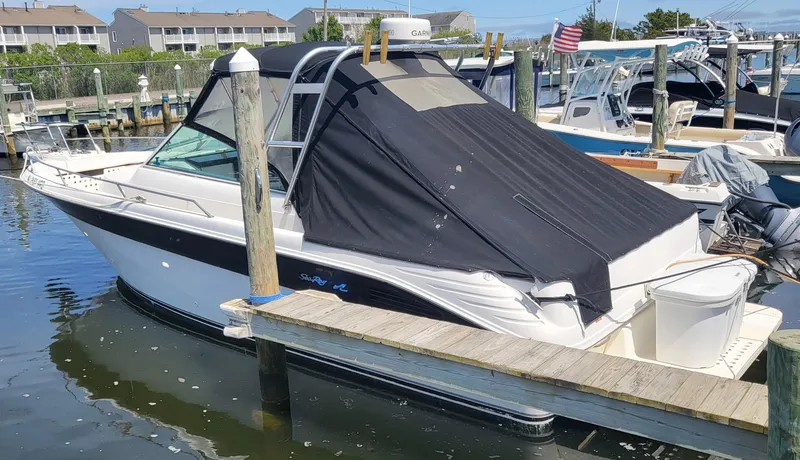 Slide: The Image of 1993 Sea Ray Laguna 29 Walkaround boat docked with black canopy cover. - 12