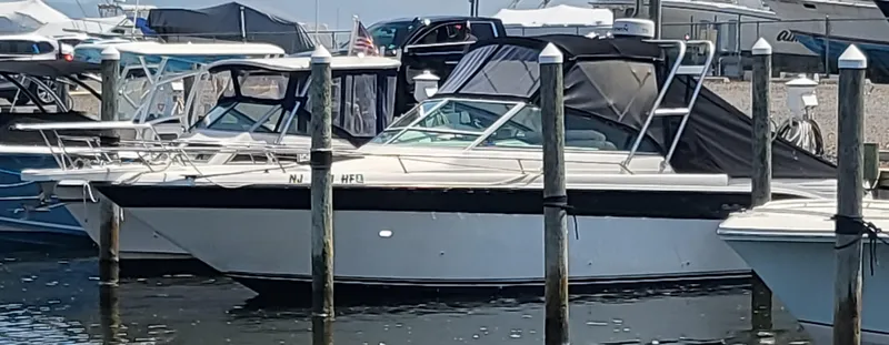 Slide: The Image of 1993 Sea Ray Laguna 29 Walkaround docked at a marina with other boats. - 13