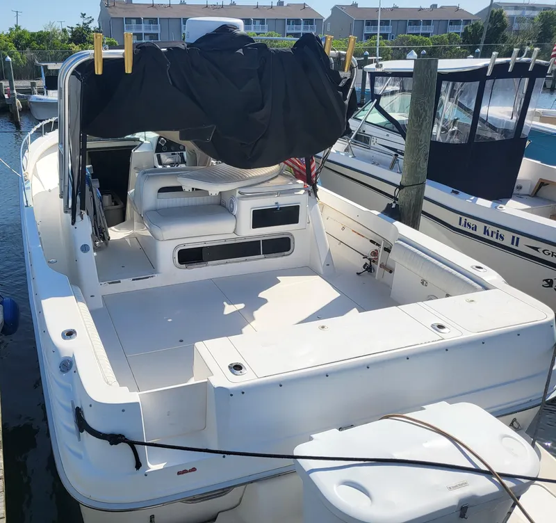 Slide: The Image of 1993 Sea Ray Laguna 29 Walkaround boat docked at marina, rear view. - 19