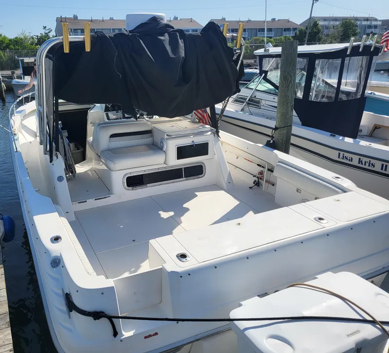 Slide: The Image of 1993 Sea Ray Laguna 29 Walkaround boat docked, featuring spacious deck and seating area. - 20