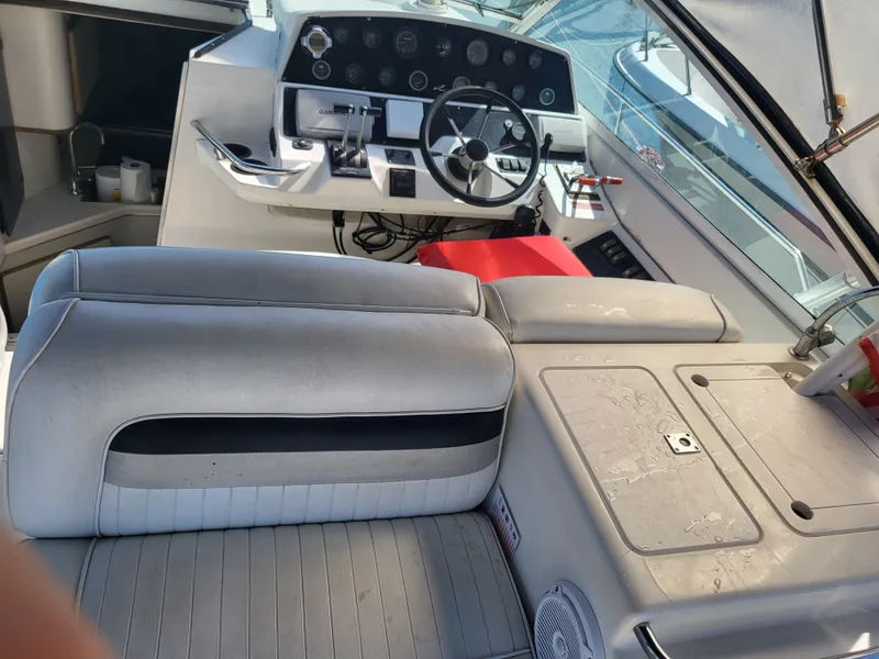 Slide: The Image of 1993 Sea Ray Laguna 29 Walkaround boat interior with steering wheel and seating area. - 21