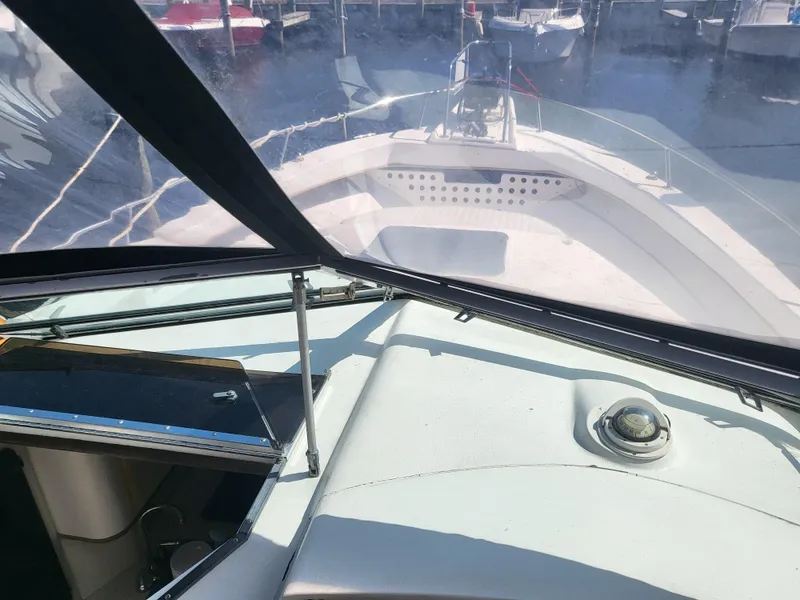 Slide: The Image of 1993 Sea Ray Laguna 29 Walkaround boat interior view with marina background. - 22