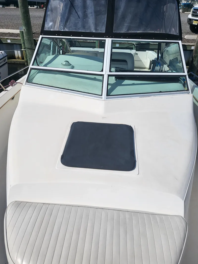 Slide: The Image of 1993 Sea Ray Laguna 29 Walkaround boat with windshield and deck hatch, docked at marina. - 23