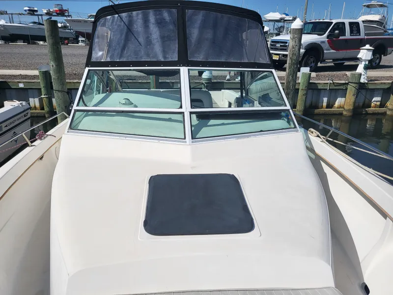 Slide: The Image of 1993 Sea Ray Laguna 29 Walkaround boat docked at marina, front view. - 25