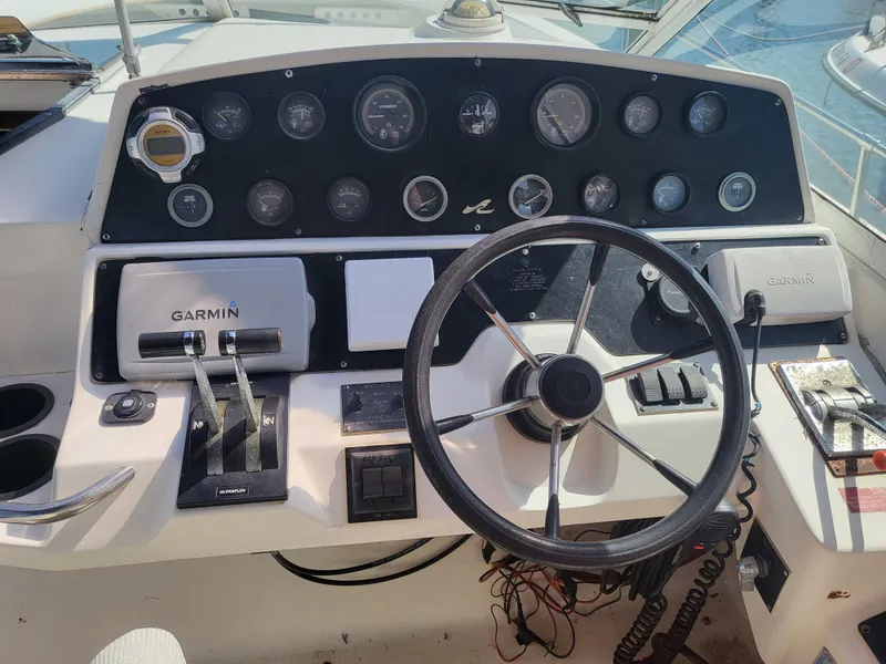 Slide: The Image of 1993 Sea Ray Laguna 29 Walkaround dashboard with steering wheel and Garmin controls. - 7