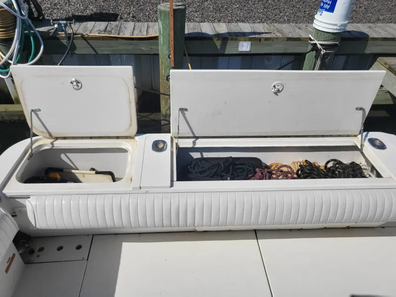 Slide: The Image of 1993 Sea Ray Laguna 29 Walkaround boat storage compartments open at dock. - 9