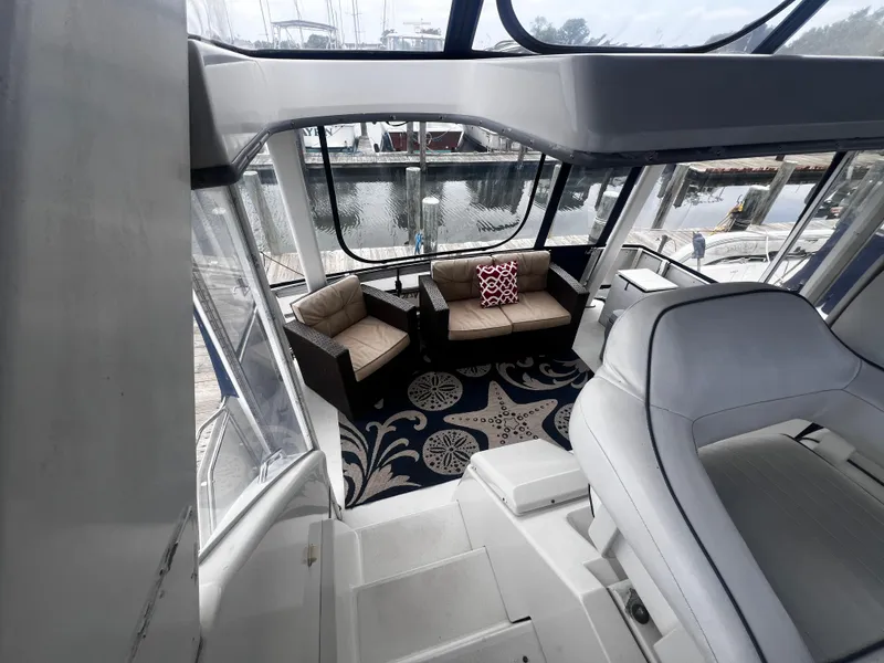 Slide: The Image of Interior of 1993 Carver 350 Aft Cabin yacht with seating area and marina view. - 12