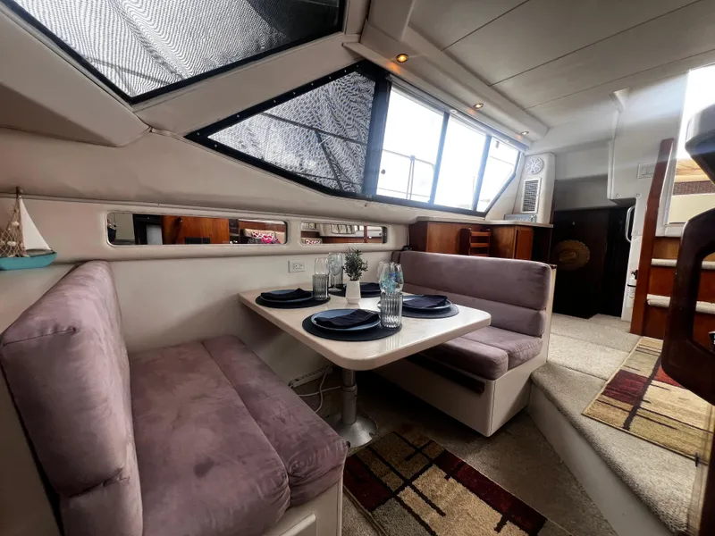 Slide: The Image of Interior of 1993 Carver 350 Aft Cabin with dining area and plush seating. - 19