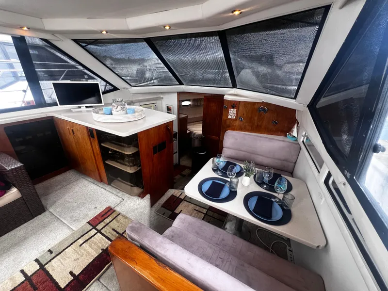 Slide: The Image of Interior of 1993 Carver 350 Aft Cabin with dining area and kitchenette. - 20