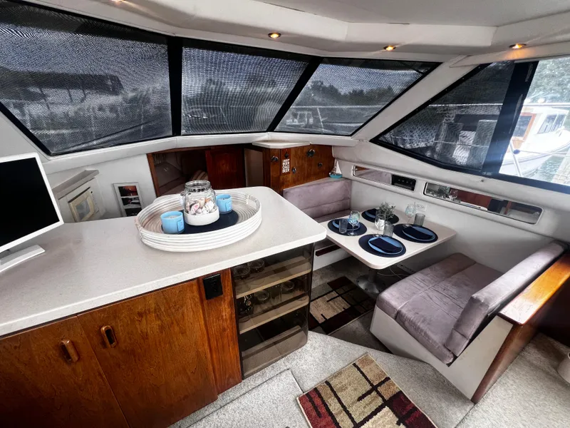 Slide: The Image of Interior of 1993 Carver 350 Aft Cabin yacht with dining area and kitchenette. - 22
