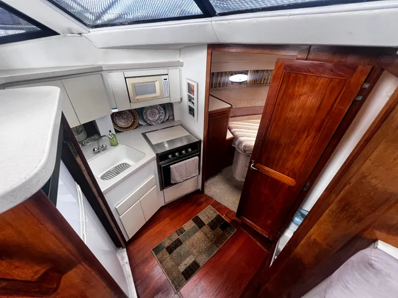 Slide: The Image of 1993 Carver 350 Aft Cabin kitchen with microwave, sink, and stove - 24