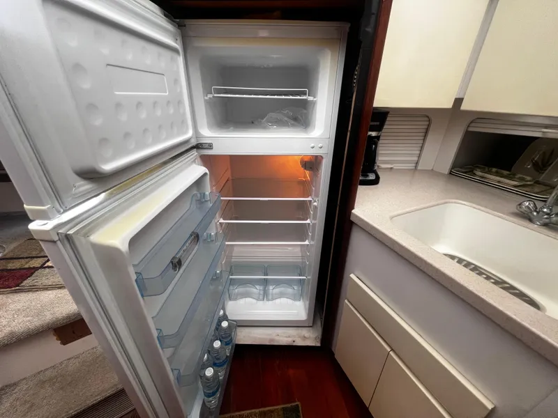 Slide: The Image of Open refrigerator in the kitchen of a 1993 Carver 350 Aft Cabin boat. - 29