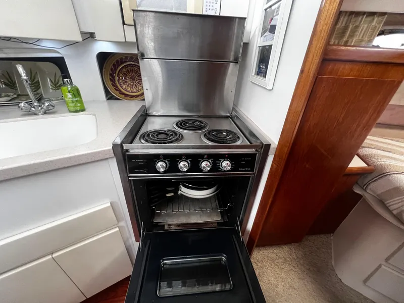 Slide: The Image of 1993 Carver 350 Aft Cabin kitchen with stove, oven, and sink. - 31