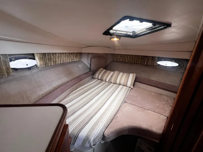Slide: The Image of 1993 Carver 350 Aft Cabin interior bedroom with bed and porthole windows. - 34
