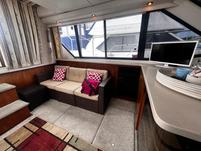 Slide: The Image of Interior of 1993 Carver 350 Aft Cabin with cozy seating area and TV. - 39