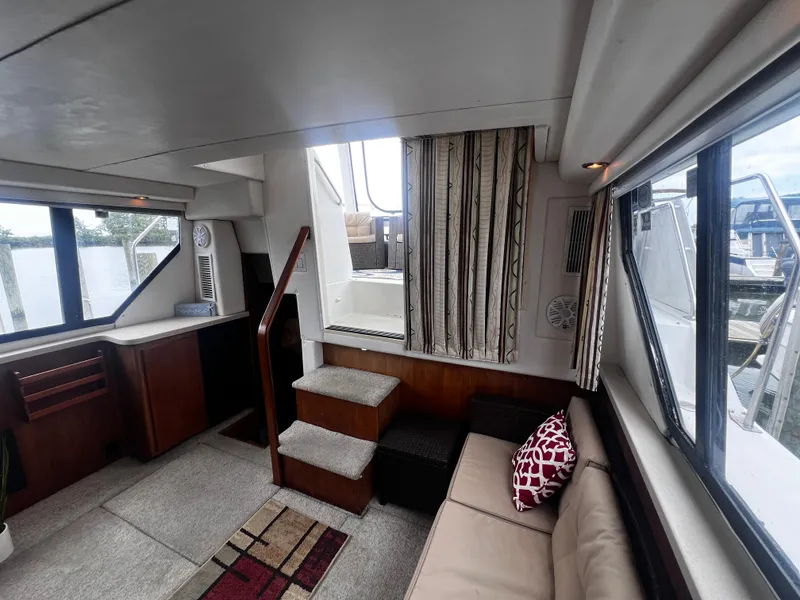 Slide: The Image of Interior of 1993 Carver 350 Aft Cabin yacht with cozy seating and large windows. - 40
