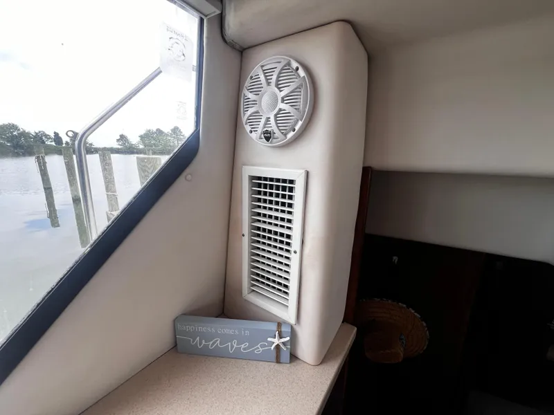 Slide: The Image of Interior of 1993 Carver 350 Aft Cabin with window, vent, and happiness comes in waves sign. - 41