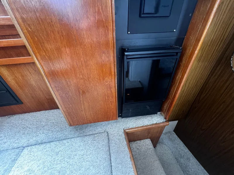 Slide: The Image of Interior of 1993 Carver 350 Aft Cabin with wooden cabinetry and carpeted steps. - 42