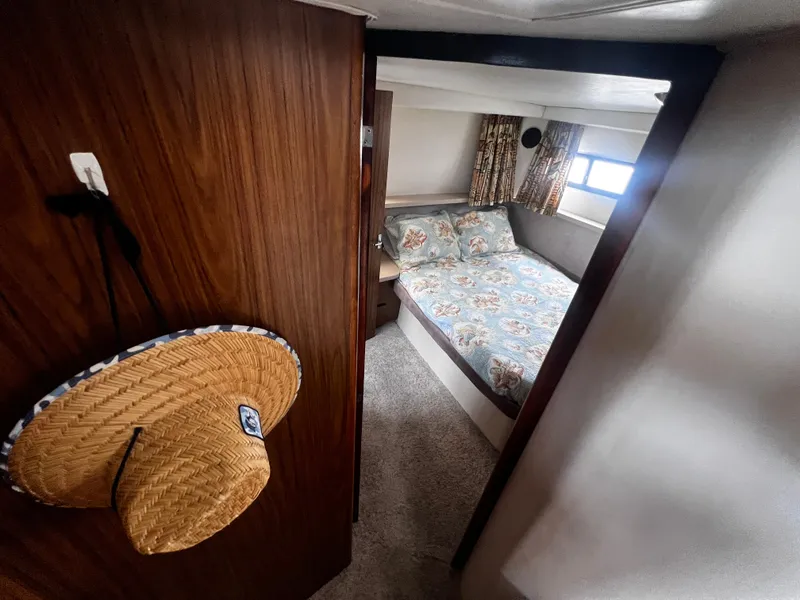 Slide: The Image of Interior cabin of 1993 Carver 350 Aft Cabin boat with bed and floral bedding. - 43