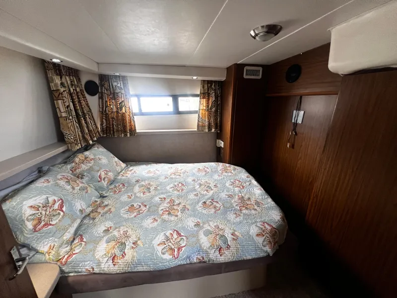 Slide: The Image of Cozy bedroom in a 1993 Carver 350 Aft Cabin yacht with floral bedding. - 44