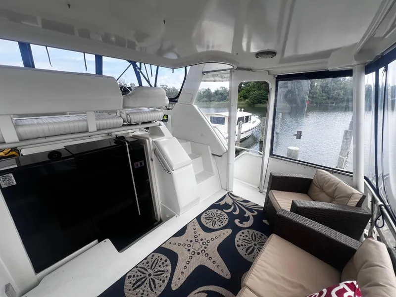 Slide: The Image of 1993 Carver 350 Aft Cabin interior with seating area and water view. - 8