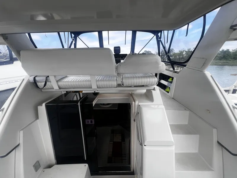 Slide: The Image of 1993 Carver 350 Aft Cabin interior view with helm and seating area. - 9