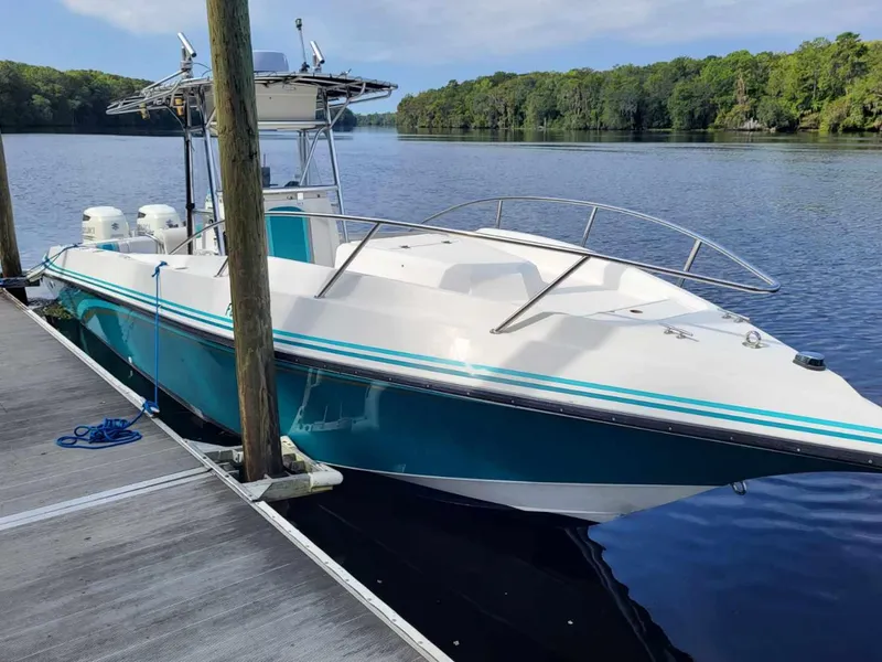 The Image of 1994 Fountain 31 CC boat docked on a calm river. - 2