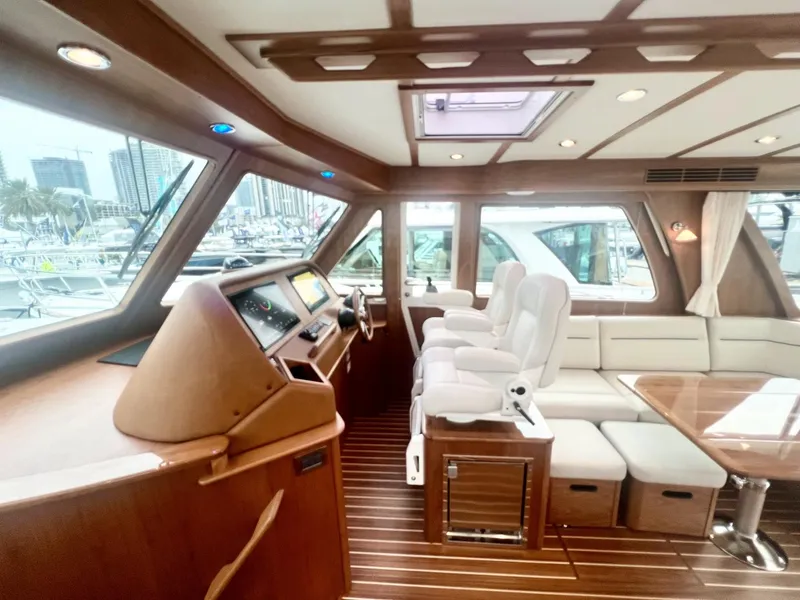 Slide: The Image of Interior of 2025 Sabre 48 Salon Express yacht with luxurious seating and wooden finishes. - 11